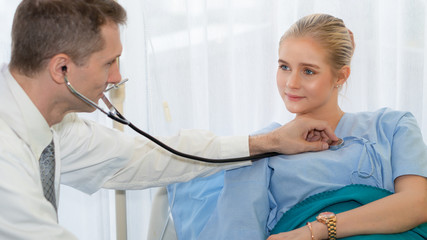 healthcare background of physical doctor examining patient with stethoscope at hospital