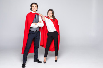 Young couple of superheroes in costumes standing with crossed arms and looking at camera isolated on white background
