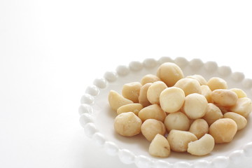 Roasted macadamia nuts on dish with copy space