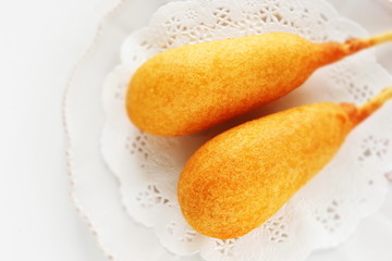 American junk food, corn dog on lace pepper with copy space