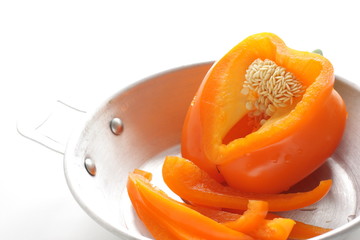 Fototapeta na wymiar Orange color chopped orange paprika on pan for prepared food ingredient