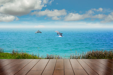 Top of wood table with sea and two dolphin background - Empty ready for your product display montage. Concept of beach in summer - Powered by Adobe