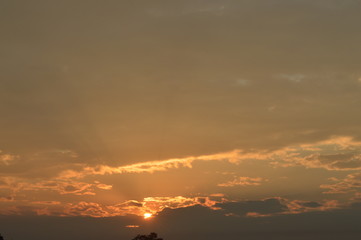 The sun shone in the morning surrounded by clouds.