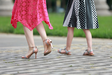 Women's feet in high-heeled sandals