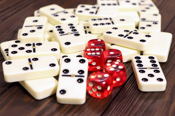 Dominoes game on a wooden table, brown background. Board game domino. Gambling. Dice on a table.