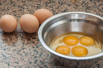 Close-up of Egg and egg yolk. Egg yolk in the stainless steel container.