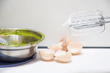 Close-up of the electric whisk with eggshell background. 