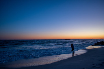 Fototapeta na wymiar Man testing ocean waters sunrise sunset