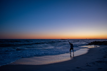 Man testing ocean waters sunrise sunset