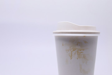 dirty brown stain on take away cup for hot coffee drink, paper mug on white background