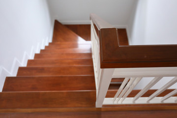 hardwood handrail banister and white steel balustrade on brown wooden stair interior decorated modern style of residential house