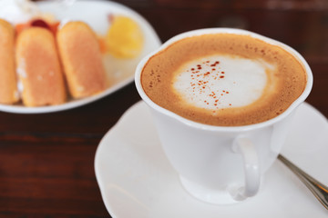 espresso hot coffee drink and orange cake put on breakfast table in the morning
