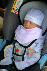 cute newborn baby sleeping in car seat safety belt lock protection drive road trip