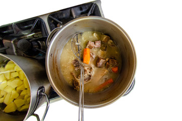 Top view saucepan with cooked Beef and Potato Soup French recipe cooked in Russia