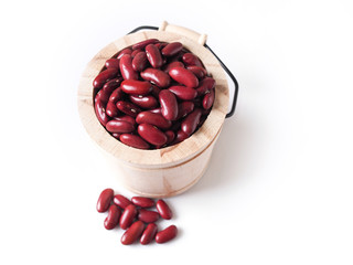 Top view of dried red beans in wooden bucket isolated on white background.