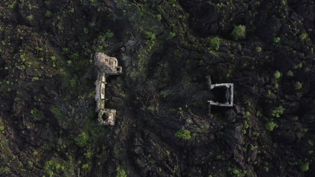Aerial cenital shot of a buried church of volcanic rocks, Paricutin.