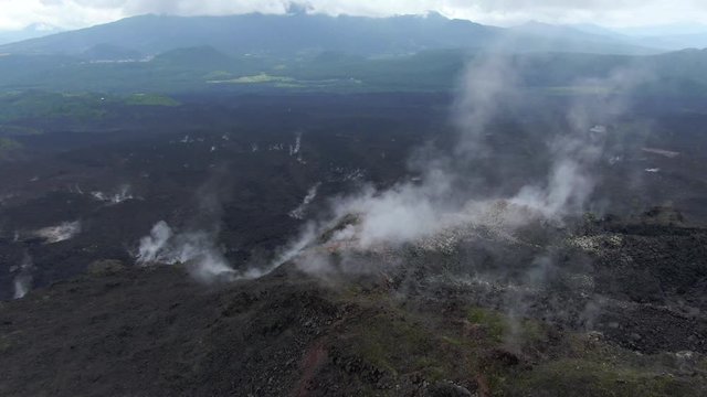 Aerial shot of vapor coming out volcanic rocks of the Paricutin volcano