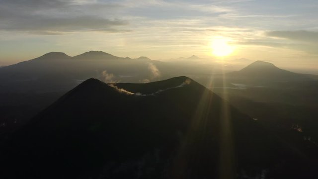Aerial shot of a volcano with vapor coming out.