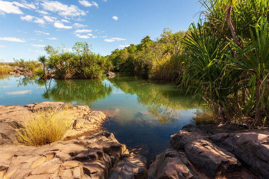 Landscape view of environmental flows from the Ord River Irrigation Scheme flowing over Ivanhoe Crossing on the old Kununurra to Wyndham Road.