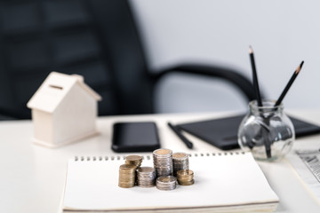Silver and gold coins stacked on the work desk,Money for business, growth and investment