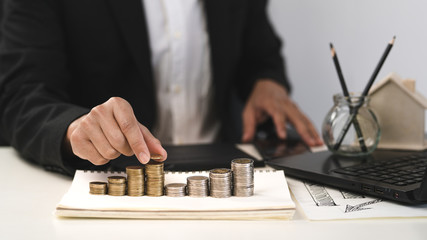 Silver and gold coins stacked on the work desk,Money for business, growth and investment