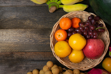 Variety of fruits with vivid color on old wooden background.