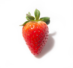 strawberry berry with foliage in close - up isolated on a white background