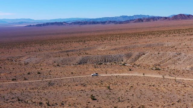 Flying and driving at the same time. A unique perspective of racing offroad down a dusty trail as the colors layer in the distance.