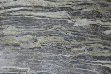 Polished stone background gray black.