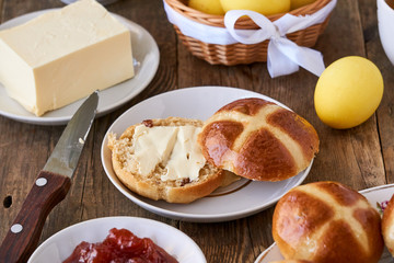 Easter table with cross buns and colored yellow eggs