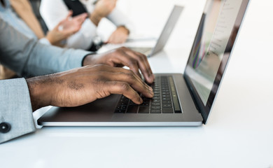 Male hands typing on a laptop.