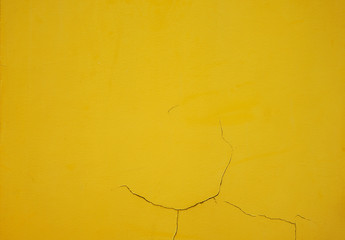 Conrete wall with cracked texture background, Yellow painted