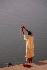 robed man doing puja at Pushkar
