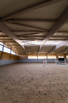  elaborate roof construction covers a newly built giant riding arena, which is filled with sand soil