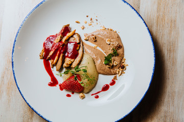 Duck fillet with chocolate sauce, berries and juniper sauce.