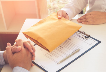 Businessman giving bribe money in the envelope,Concepts of combating bribery and corruption