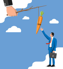 Carrot on a stick in hand and businessman. Motivation, stimulus, incentive and reaching goal concept metaphor. Fishing wooden stick with hanging carrot