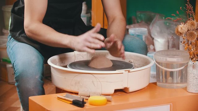 Pottery - the master is begining to mold clay on the potter's wheel
