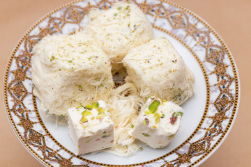 Cubes of cotton candy and chekme halva on a saucer, traditional