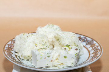 Cubes of cotton candy and chekme halva on a saucer, traditional