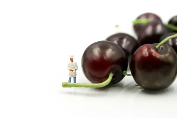 Miniature people : chef with cherrys,cherry month concept.