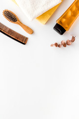 Bath set. Shampoo, towel, brush on white background top-down frame copy space