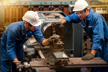 Technicians and engineers are working on machines in a factory. Twins Caucasian man Mechanical Engineer checking equipment in the industrial.