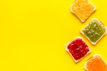 Toast with jam. Colorful set on yellow background top-down frame copy space