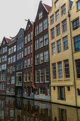 Beautiful colorful houses on a canal in Amsterdam. Vertical.