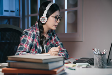 Young female student preparing for exams at home in dark bedroom at night. asian korean college...