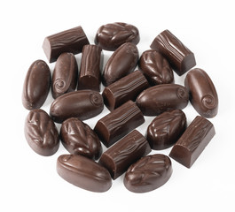 Dark chocolate candies on a light background