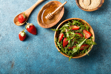 Arugula salad with quinoa on blue concrete table. Dietary food.