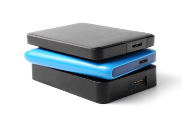 Several external drives SSD or HDD with a large amount of memory on a white background, close-up.