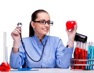 Young doctor with red heart isolated on white